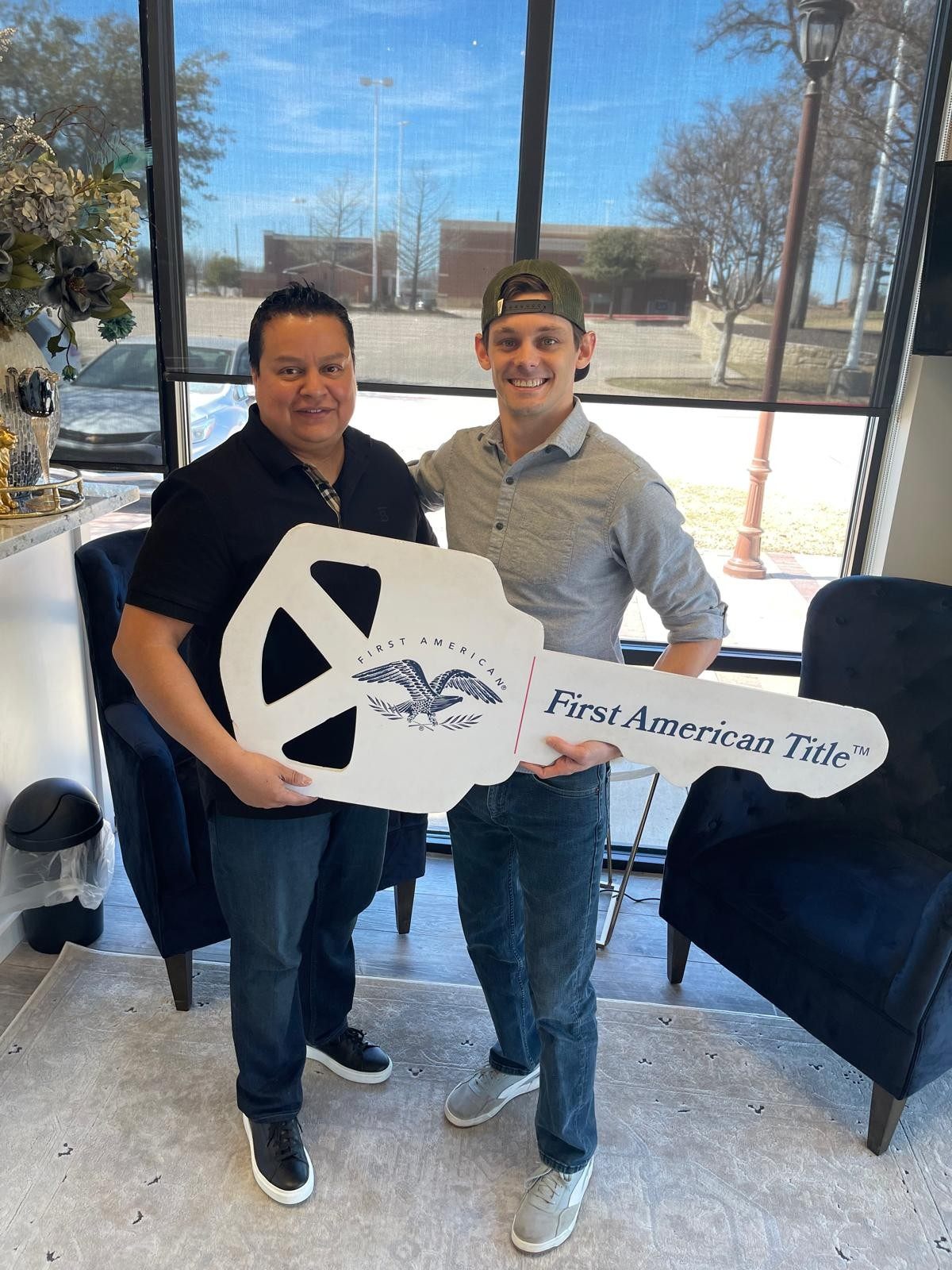 Sergio Bazan with a client holding the closing key at his Mesquite office